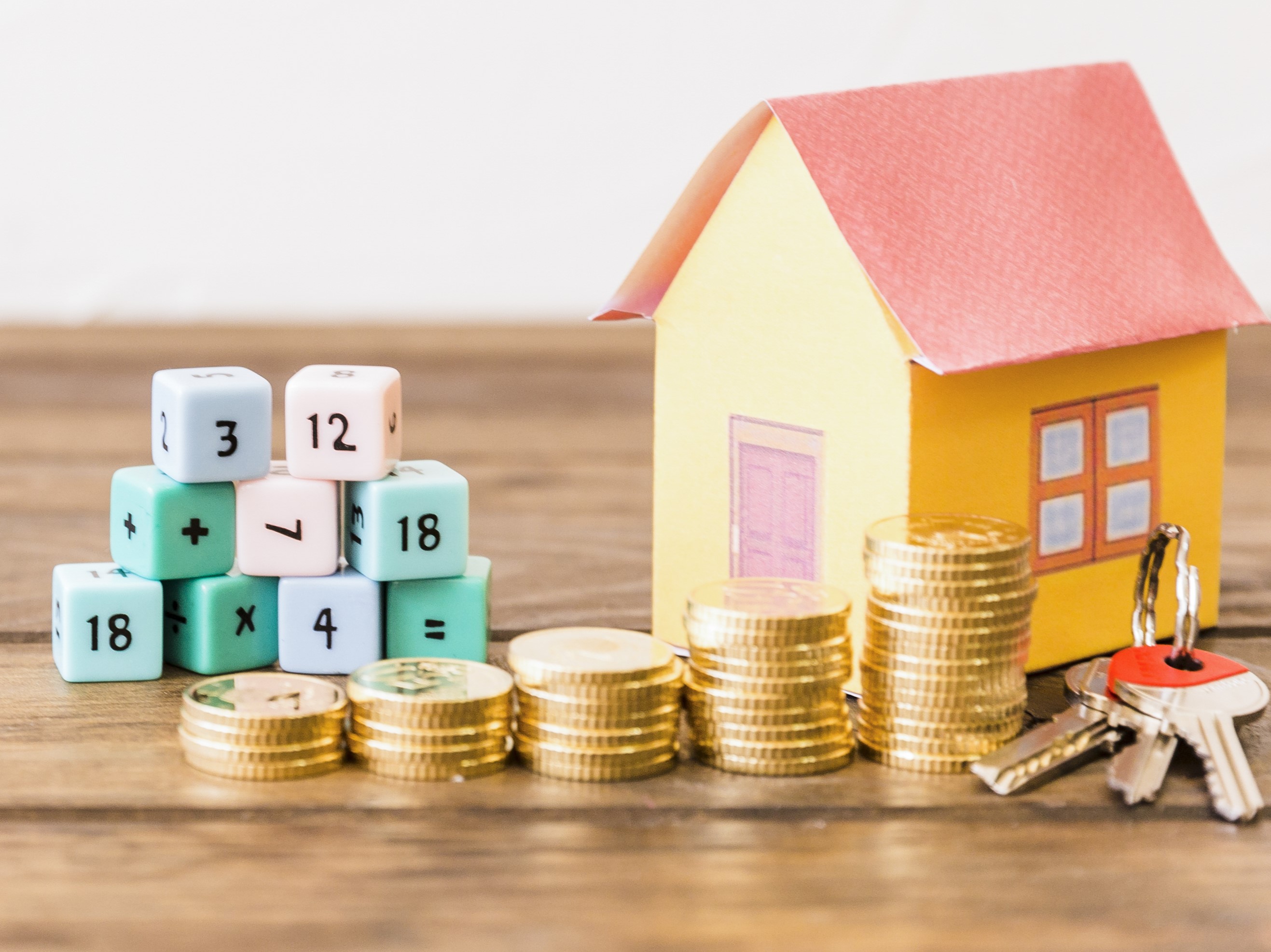 Romanian housing and economy concept with house model, coins and calculation blocks